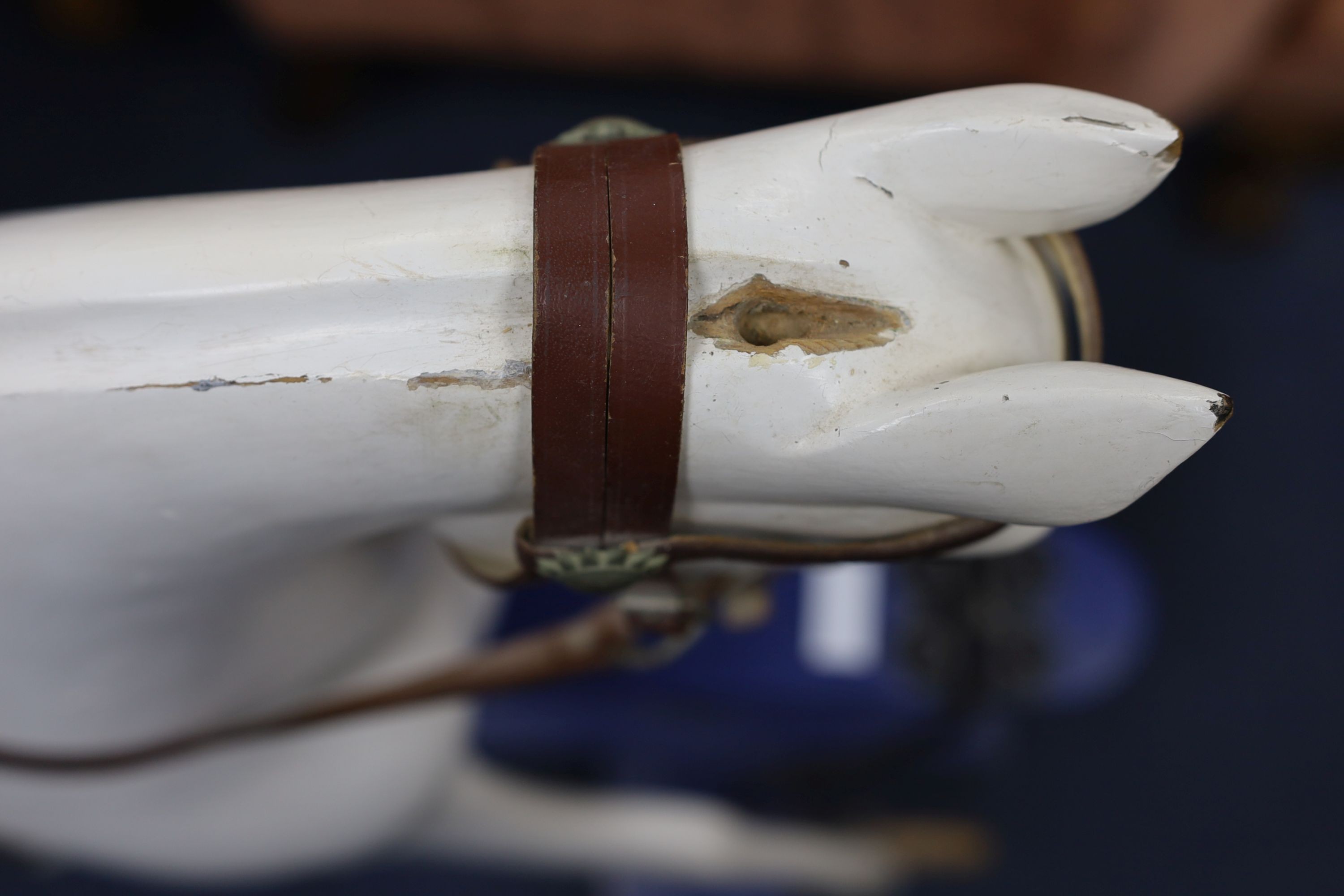 An early 20th century rocking horse on painted safety frame, (re-painted) width 126cm, height 114cm